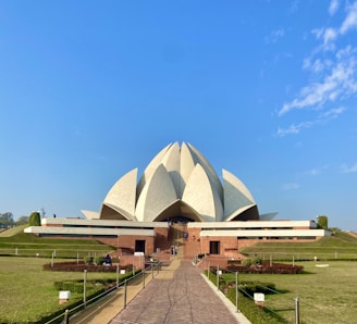 a large white building with a long walkway in front of it
