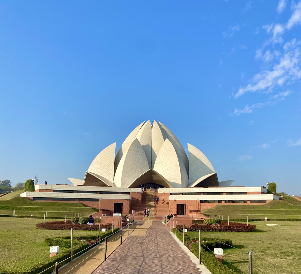 a large white building with a long walkway in front of it