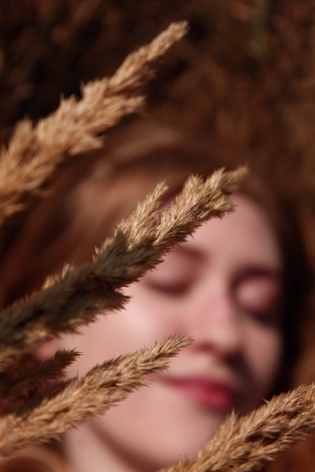 a close up of a woman with her eyes closed