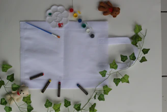 Close-up of a durable canvas storage bag filled with craft supplies on a work desk.