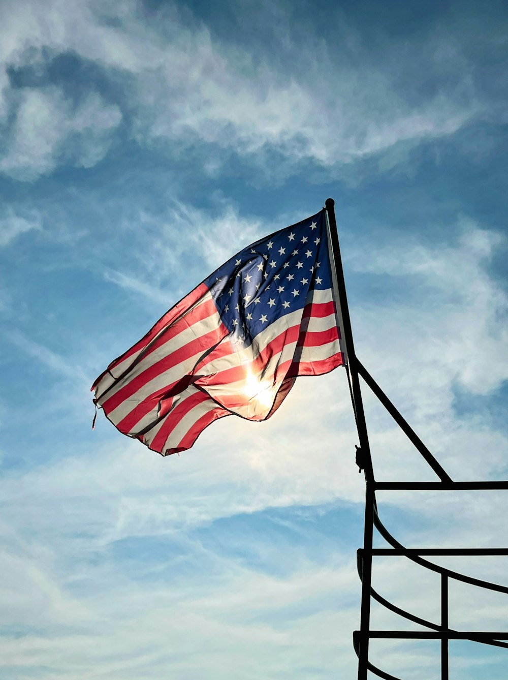 a large american flag flying in the sky