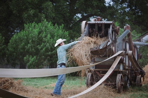 A photo of a farmer using feeding equipment.