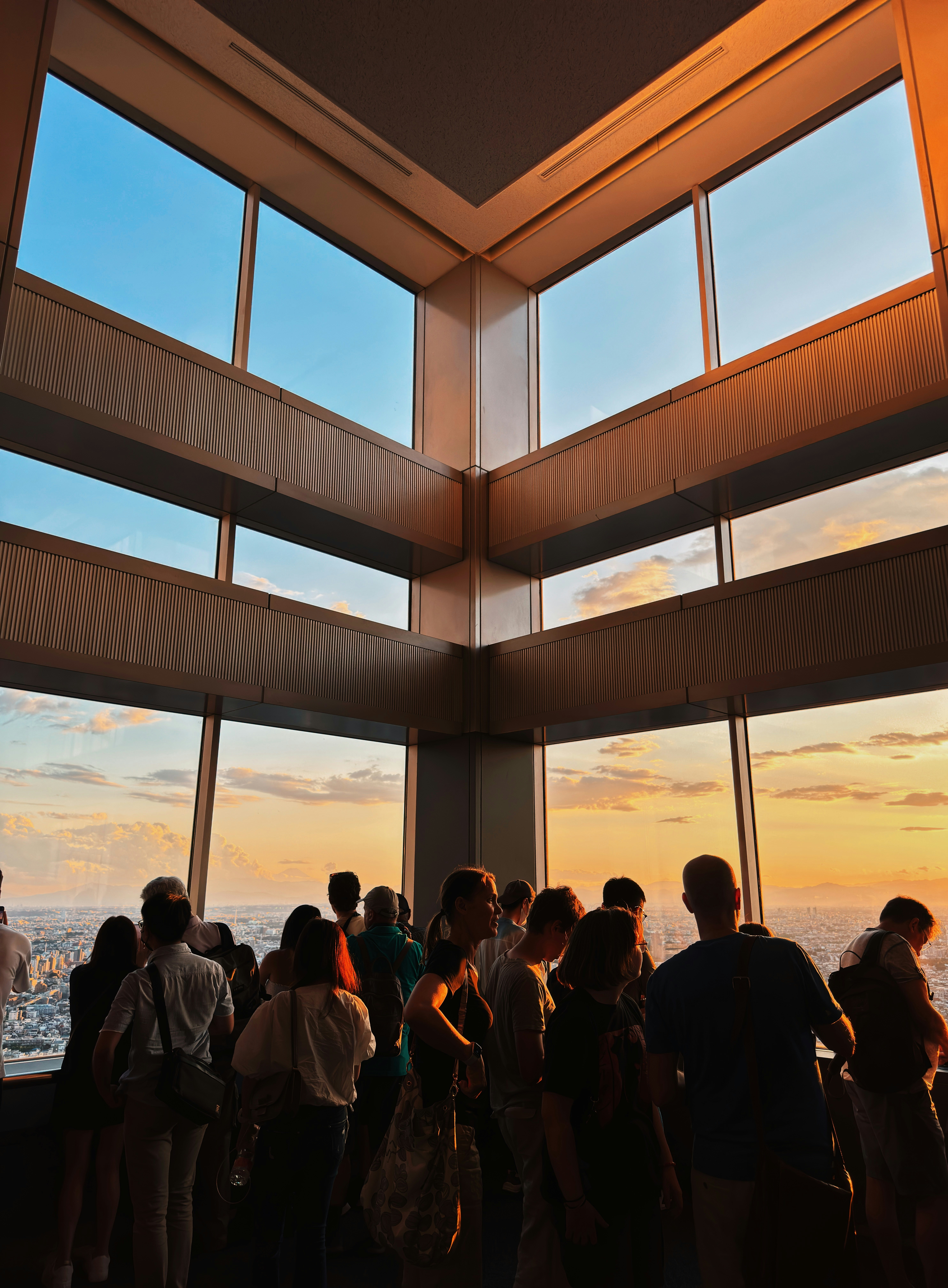 a group of people standing in front of a window