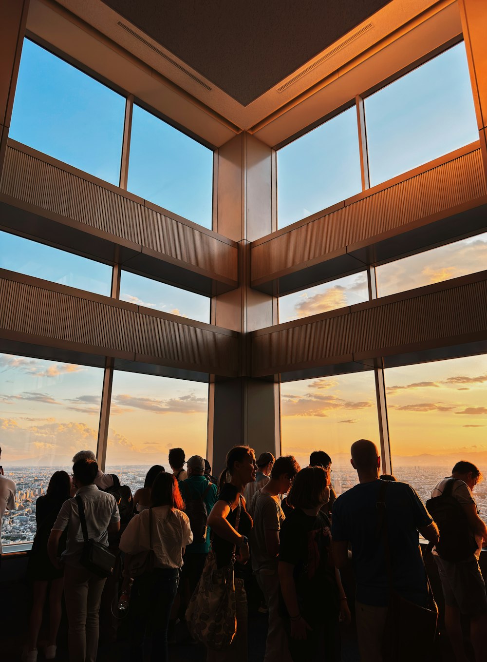 a group of people standing in front of a window