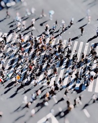 a group of people walking across a street