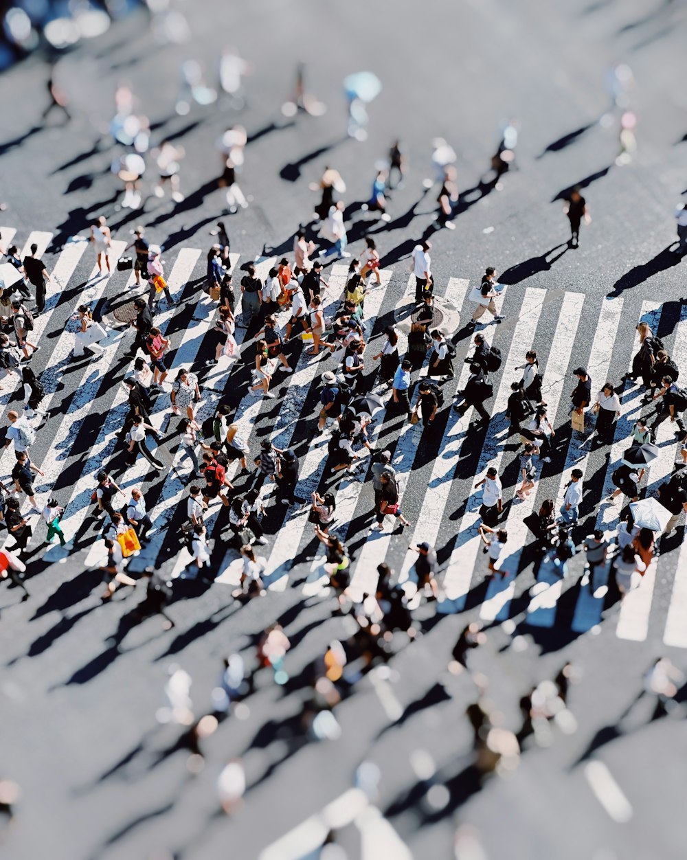 a group of people walking across a street