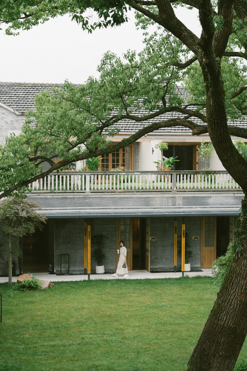 a bride standing in front of a large house