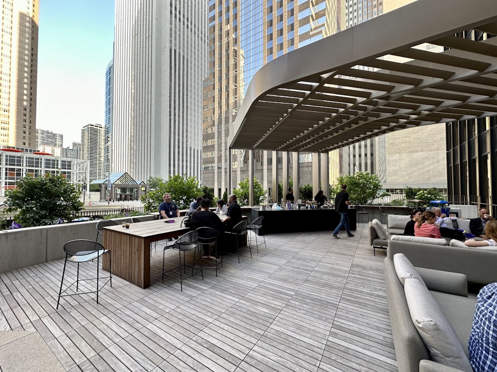 a group of people sitting at tables on a roof