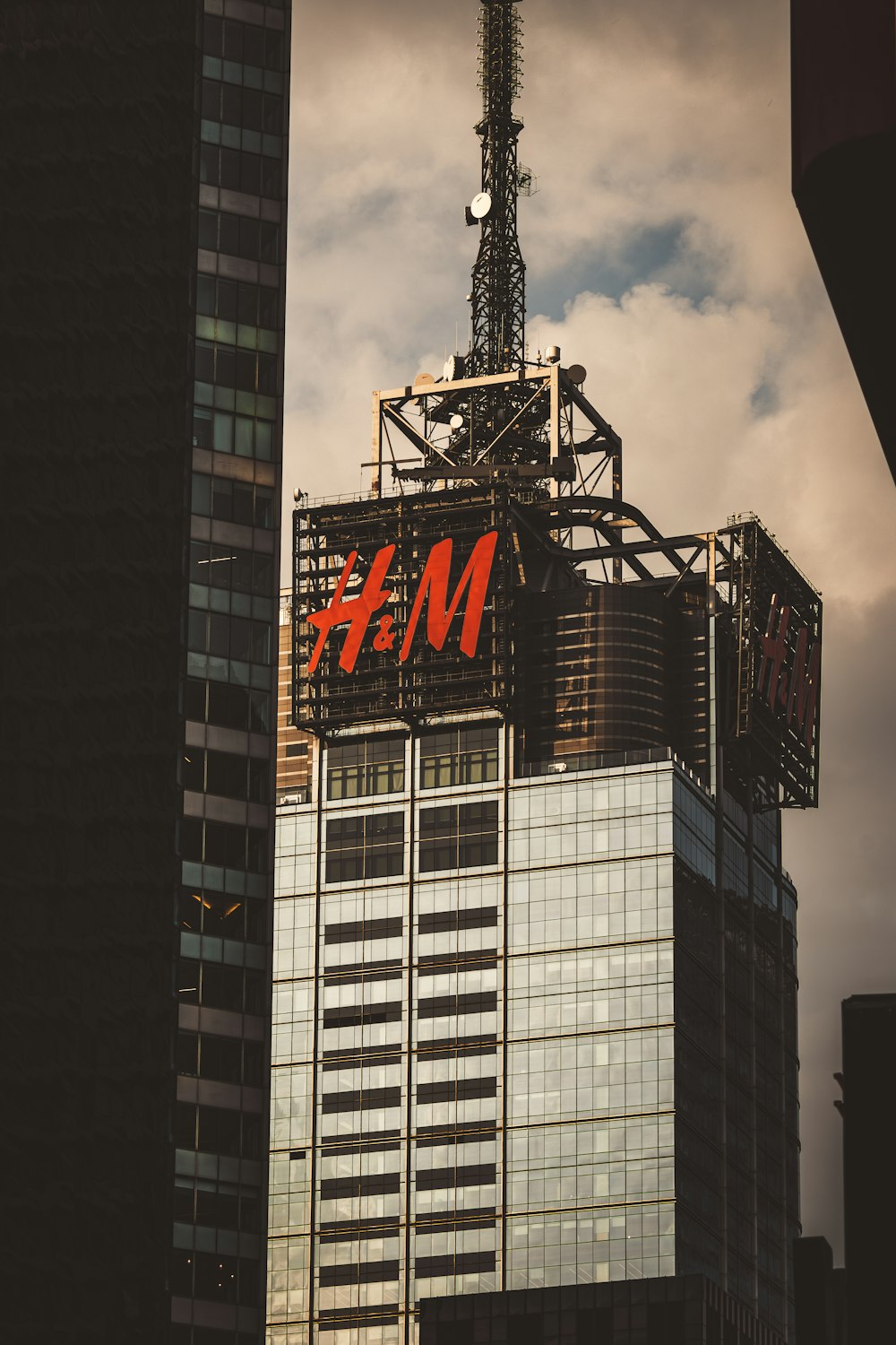 a tall building with a red h & m sign on top of it