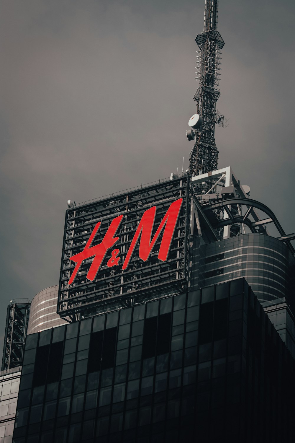 a tall building with a red h m logo on it