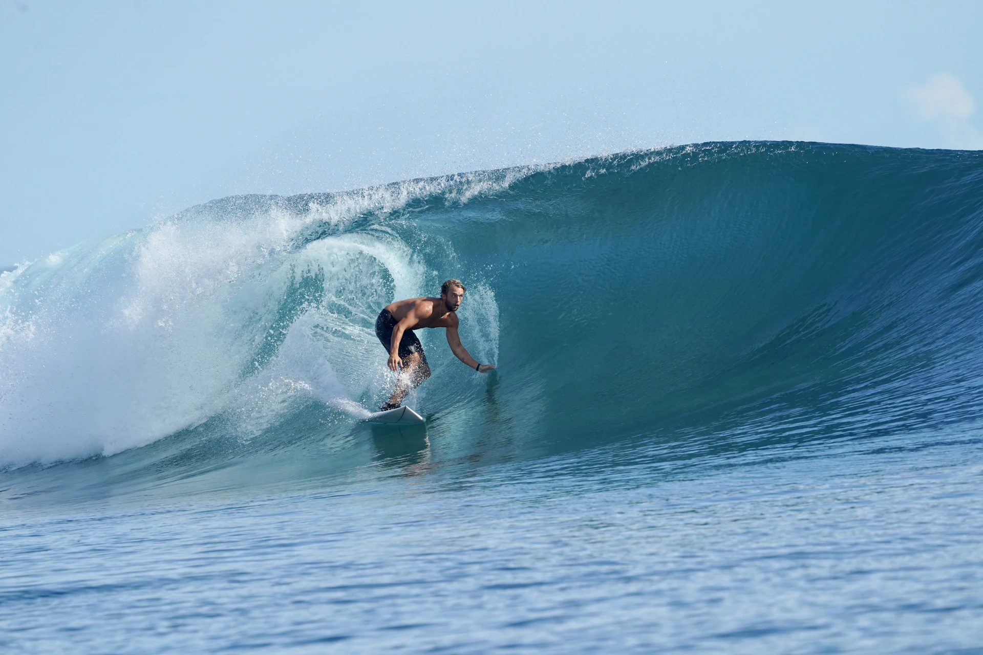 a man riding a wave on top of a surfboard