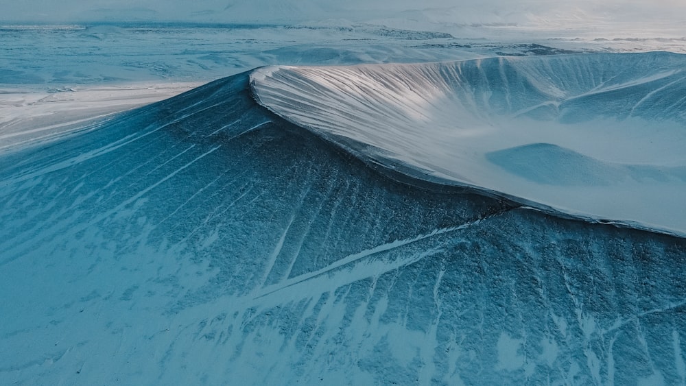 an aerial view of a mountain covered in snow