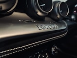 Close-up of a custom car's detailed interior with influencer branding visible.