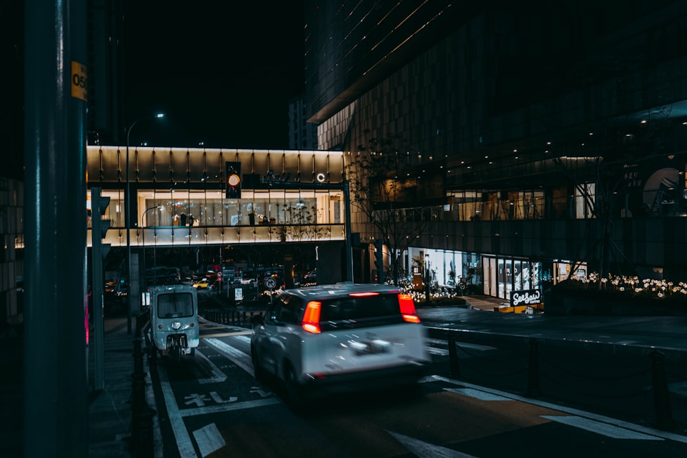 a car driving down a street at night