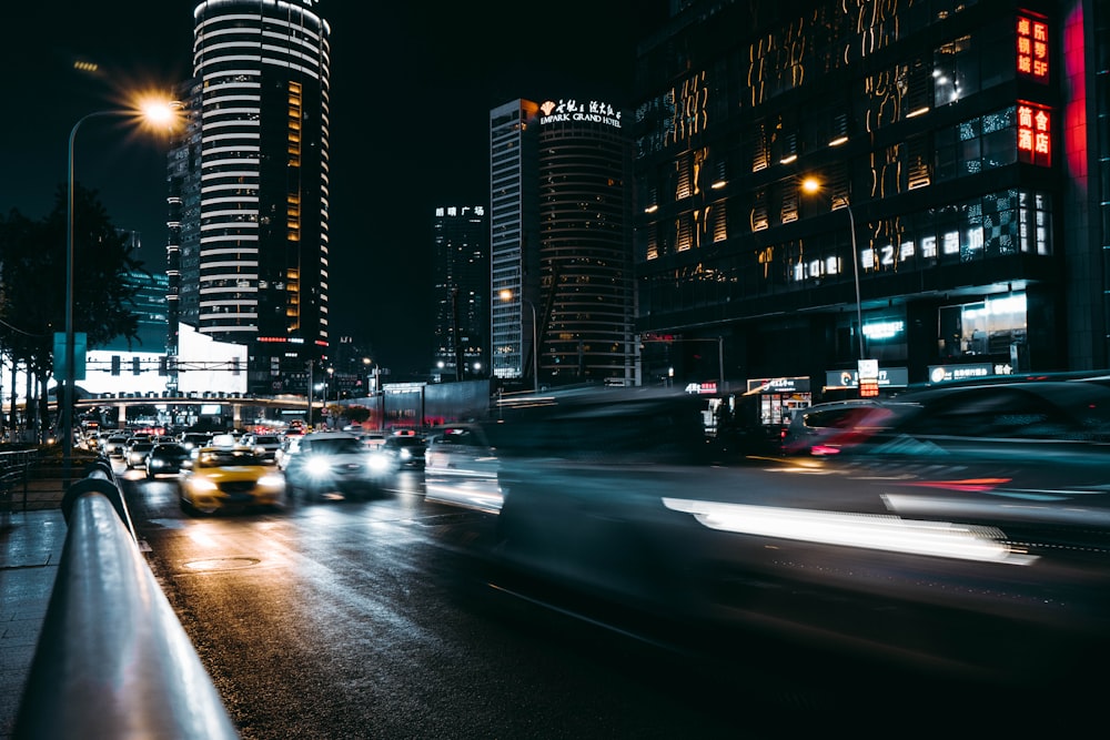 a city street filled with lots of traffic at night