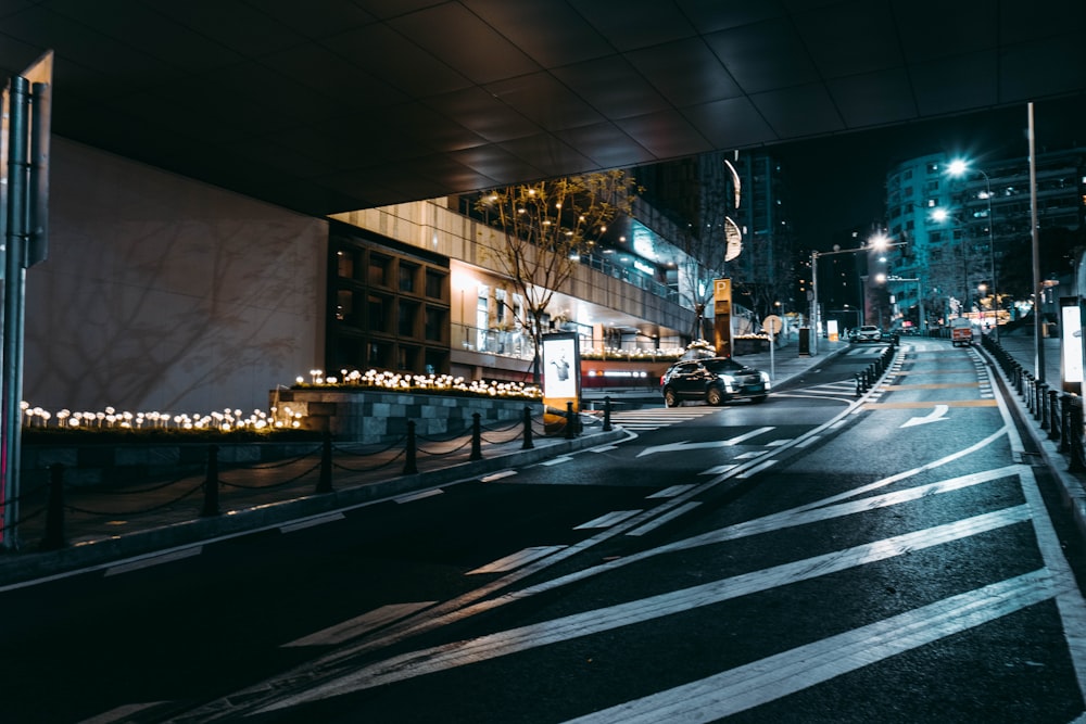 a city street at night with lights on the buildings