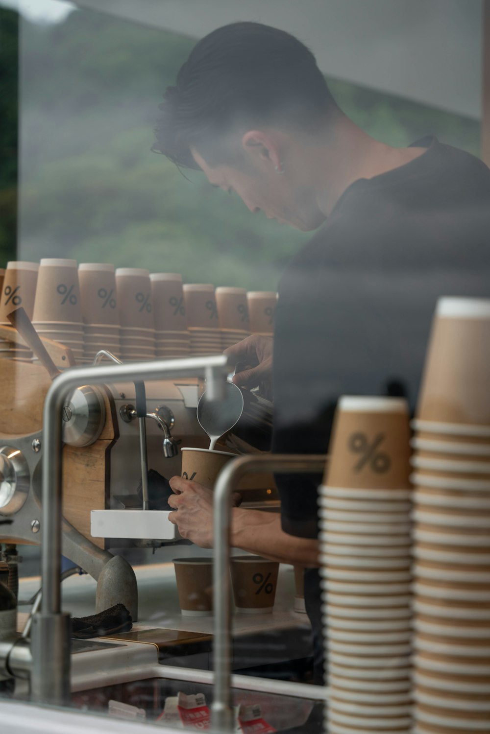 a man working on a machine in a coffee shop