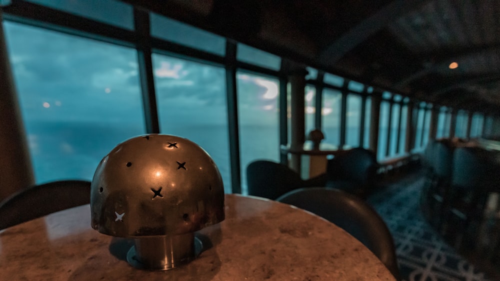 a helmet sitting on top of a table next to a window