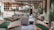 A stylish and elegant lounge area features plush seating with a mix of green and gray armchairs. Zebra-patterned cushions and footrests add a playful touch to the sophisticated decor. The space includes potted plants, enhancing the fresh and modern atmosphere. A polished wooden bar with a circular design and ambient lighting is positioned at the back, creating a welcoming focal point.