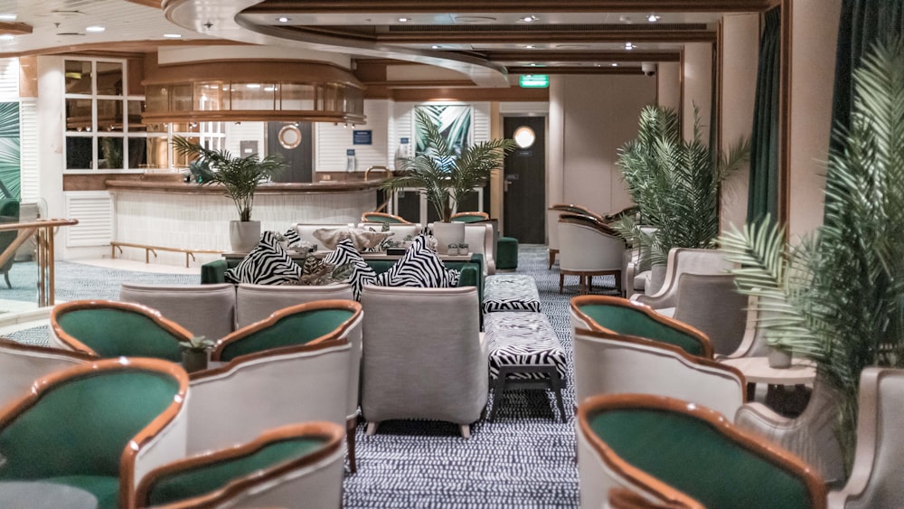 a restaurant with green and white chairs and palm trees