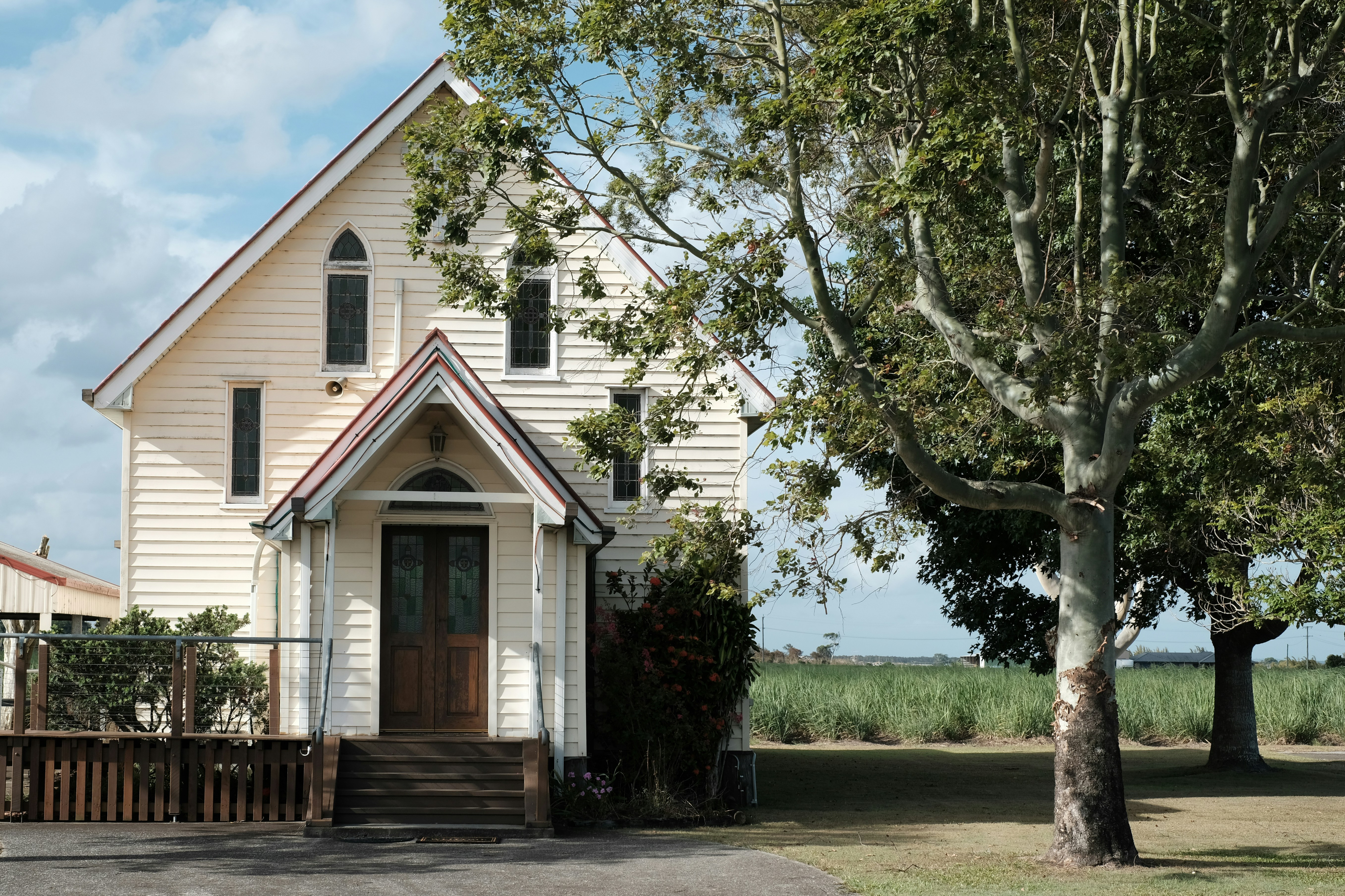a small white church with a brown door