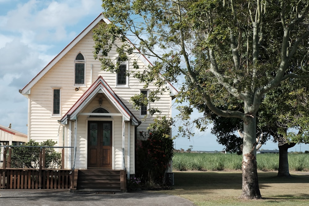 a small white church with a brown door