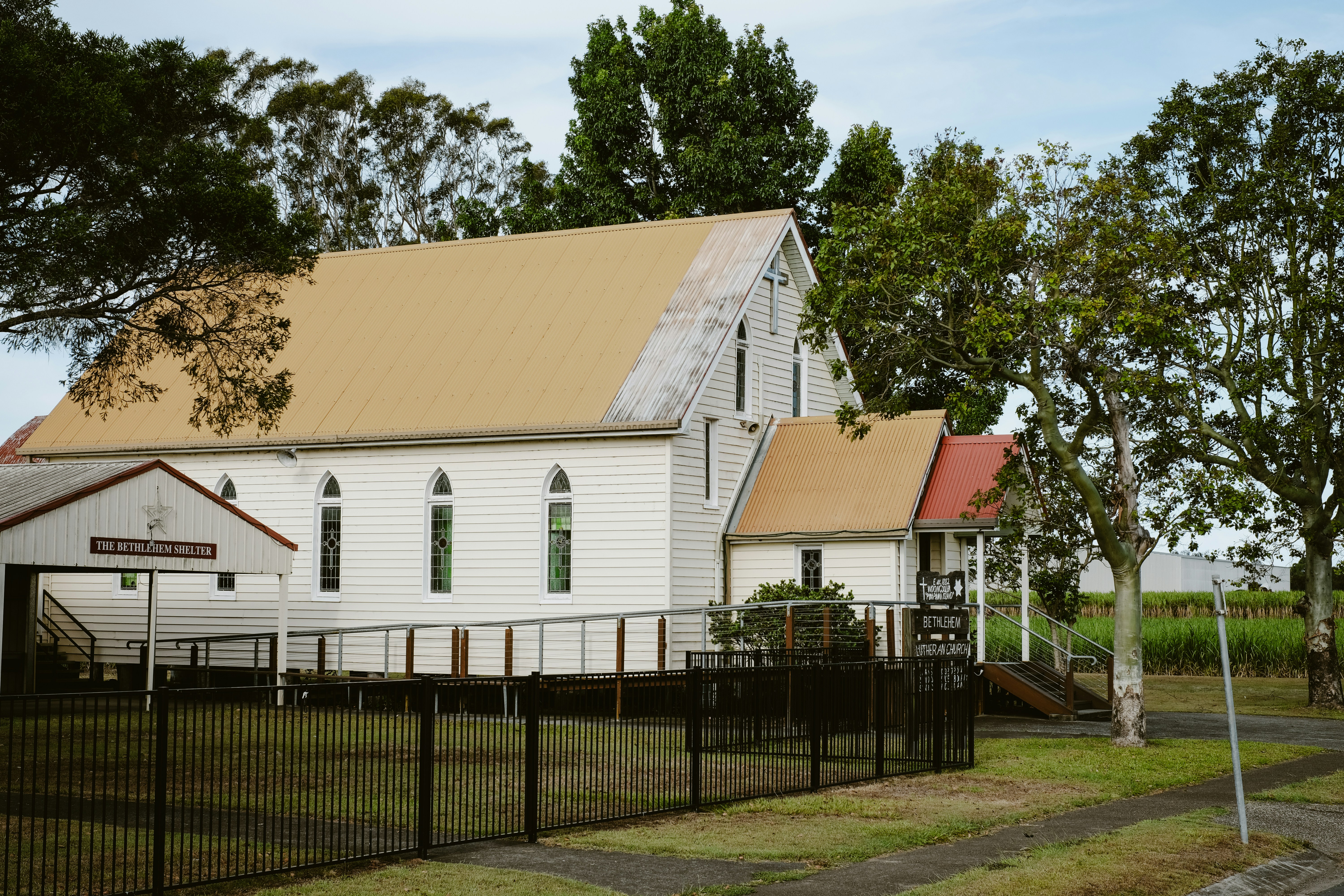 woman wearing yellow long-sleeved dress under white clouds and blue sky during daytime