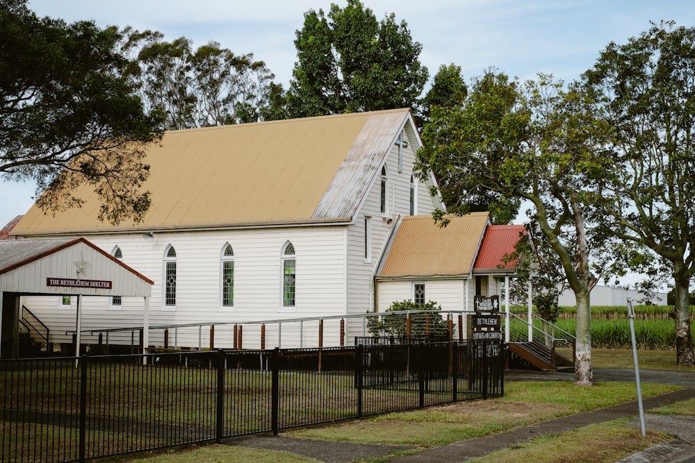 a white church with a fence around it