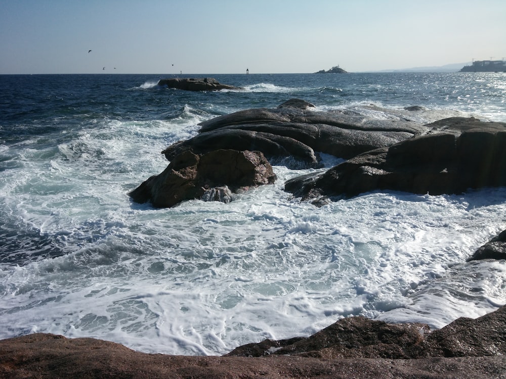 a body of water with rocks in the foreground