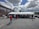 A group of people enjoying an outdoor event under a large tent.