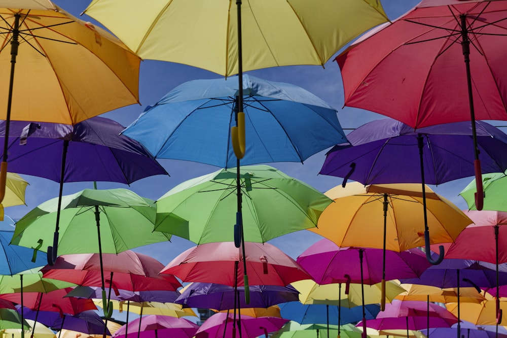 a bunch of umbrellas that are in the air