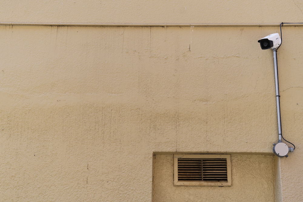 a security camera attached to the side of a building