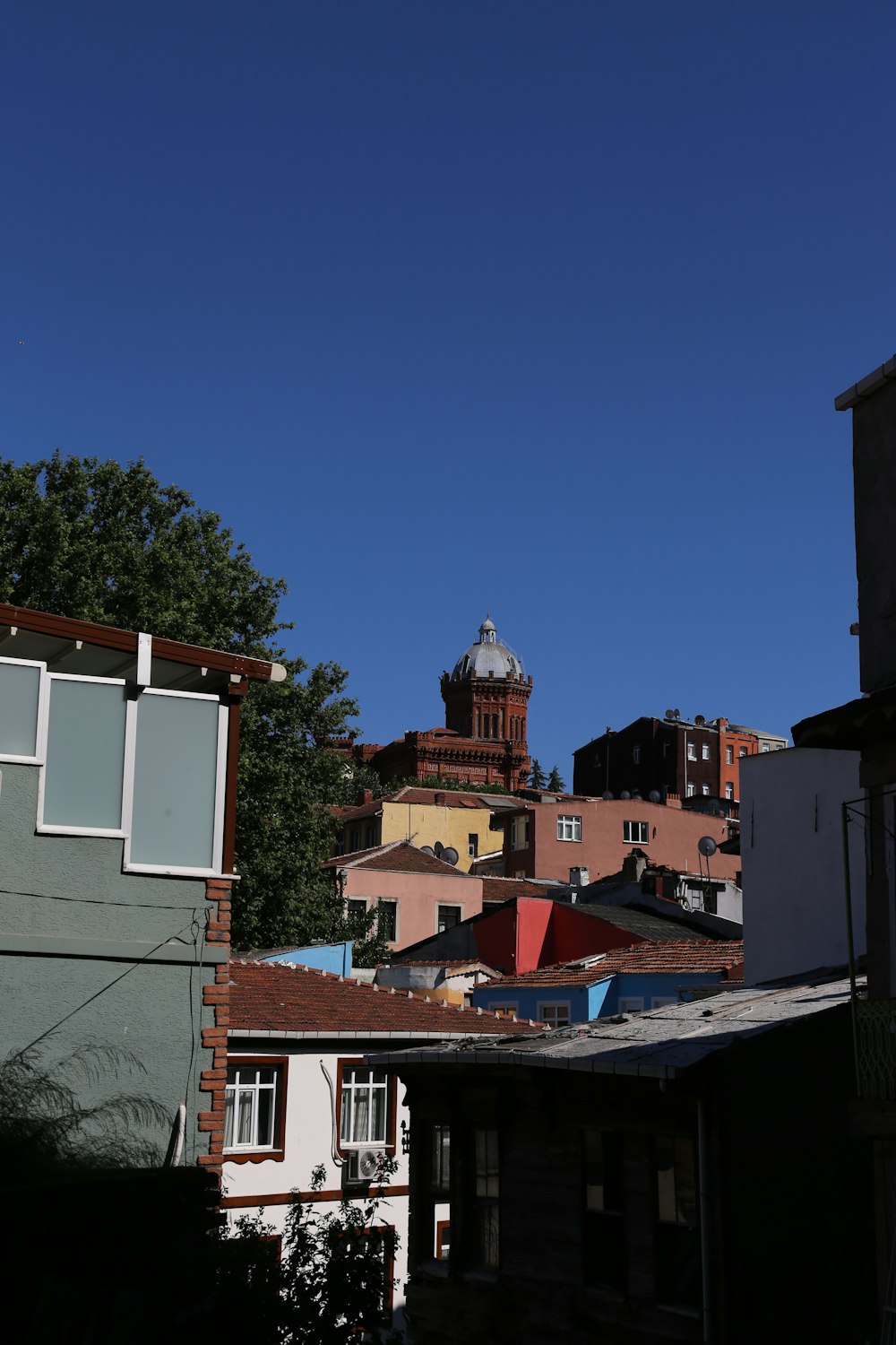 a view of a building with a clock tower in the background