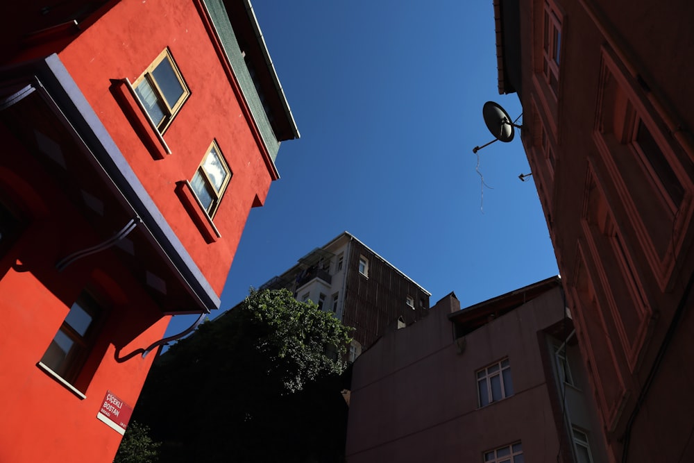 a red building and a blue sky in a city