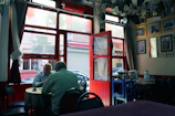 Mentor and young adult sharing a conversation over coffee in a welcoming setting