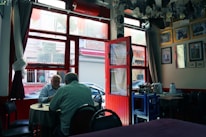 A cozy coffee shop scene with two mature individuals engaged in a warm conversation.