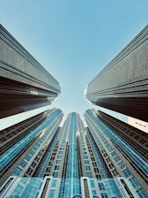 looking up at tall buildings in a city