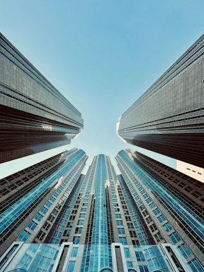 looking up at tall buildings in a city
