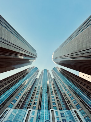 looking up at tall buildings in a city