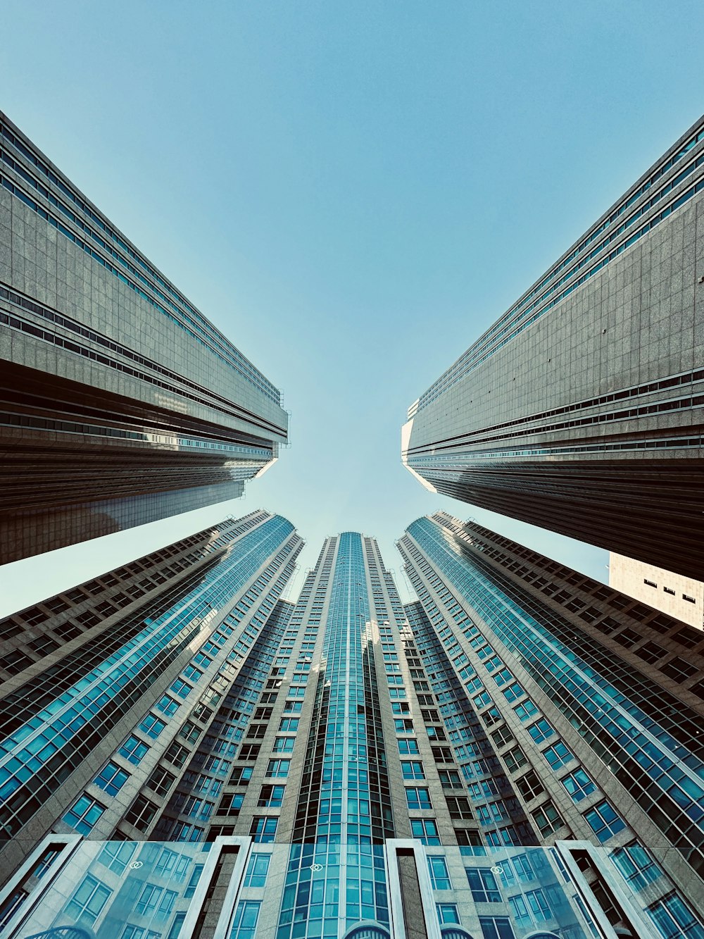 looking up at tall buildings in a city