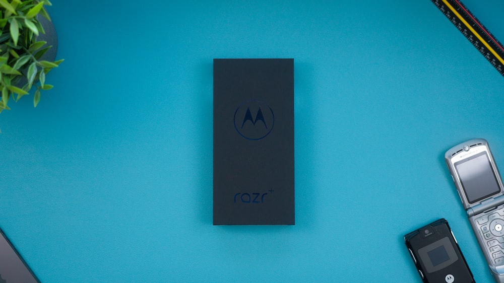 a motorola cell phone sitting on top of a blue table