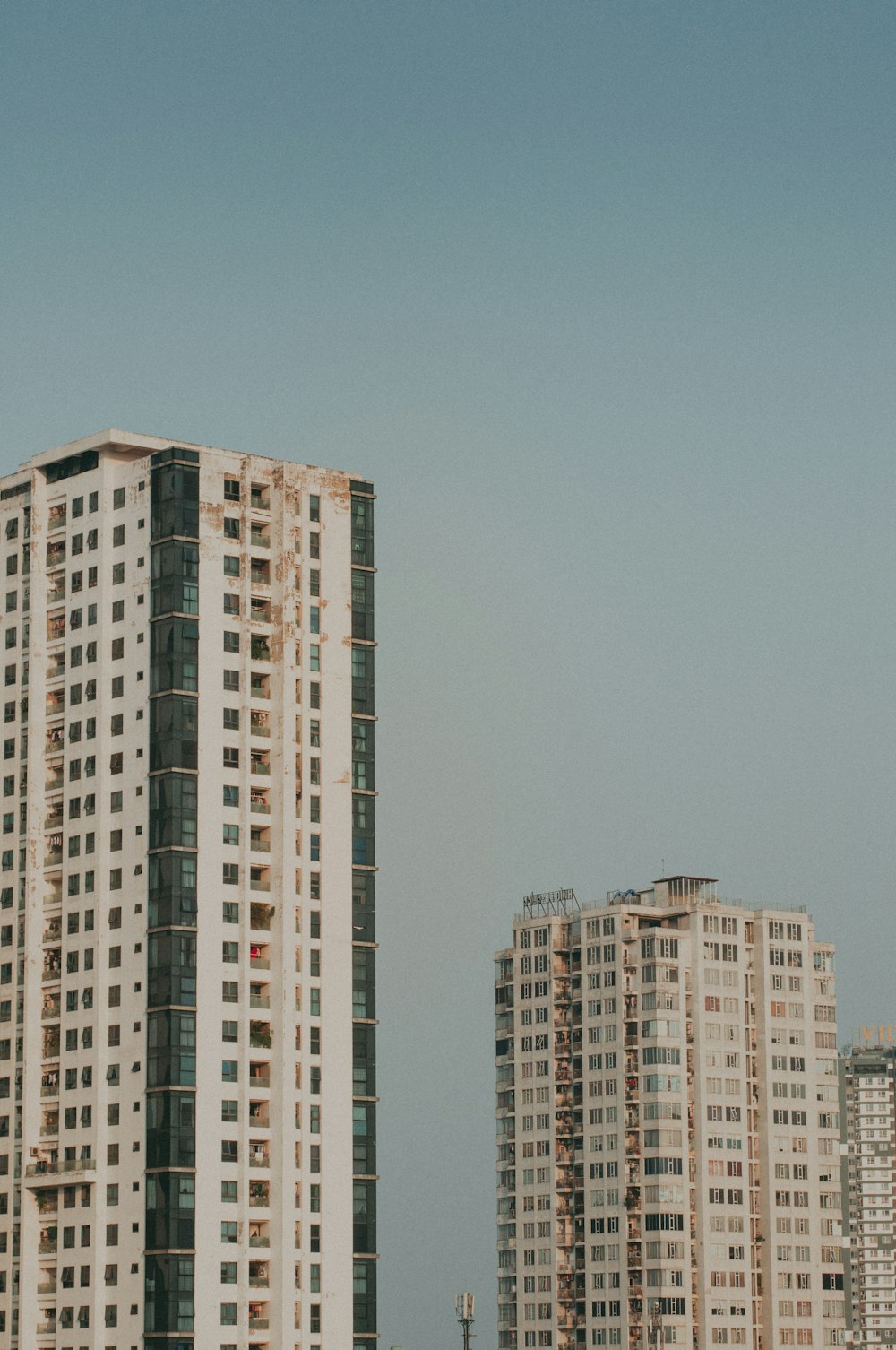 a couple of tall buildings sitting next to each other