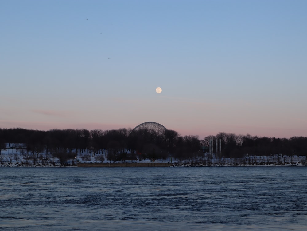 a large body of water with a building in the background