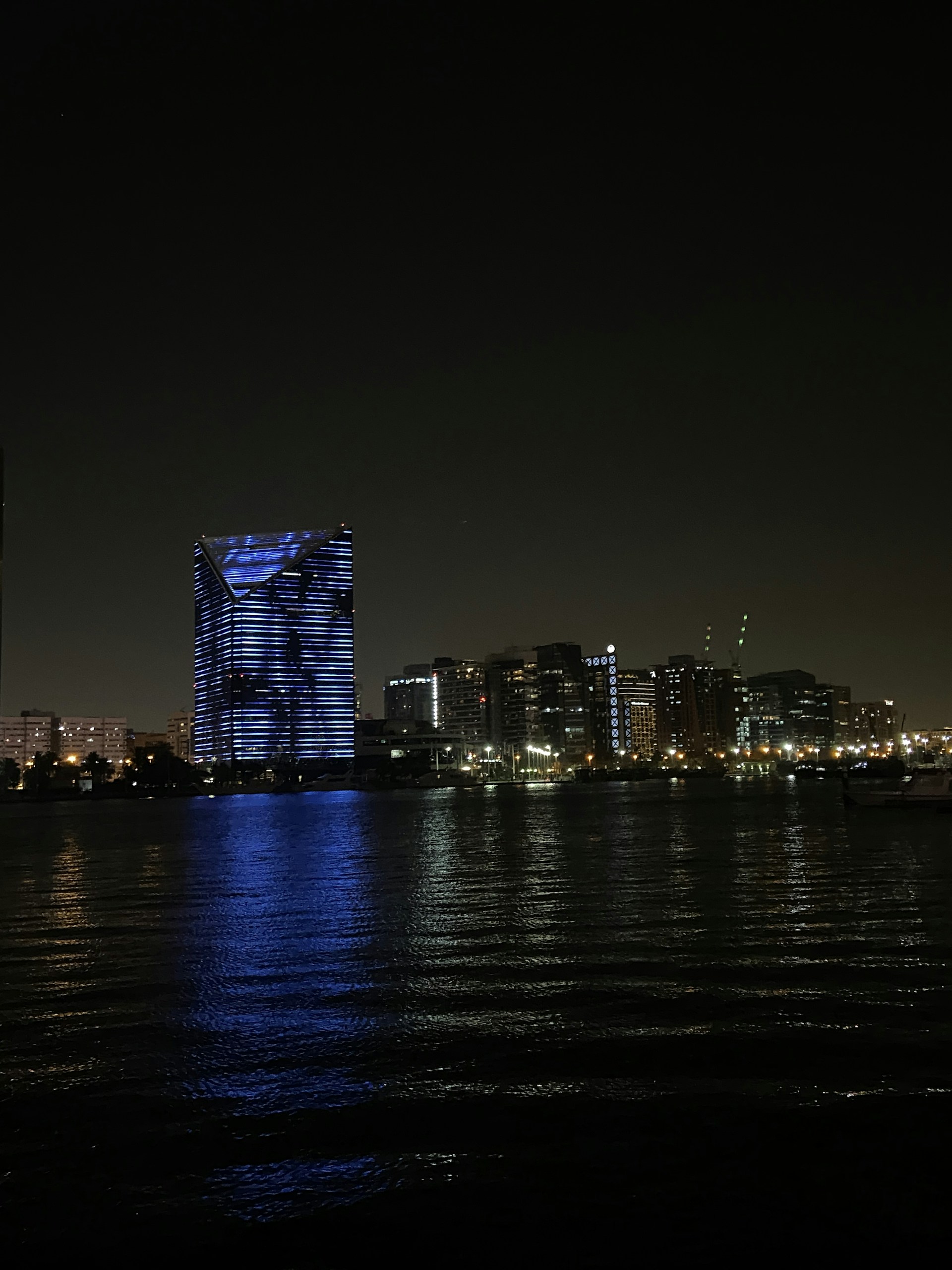 a night view of a city with lights reflecting off the water