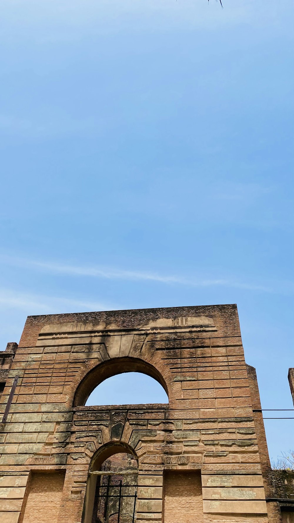 a tall brick building with an arched doorway