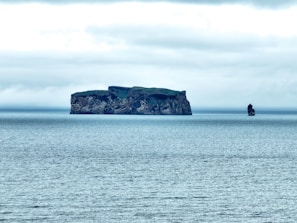 a large body of water with a small island in the middle of it
