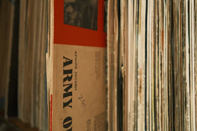 A close-up of vinyl records stacked with colorful album covers peeking out.