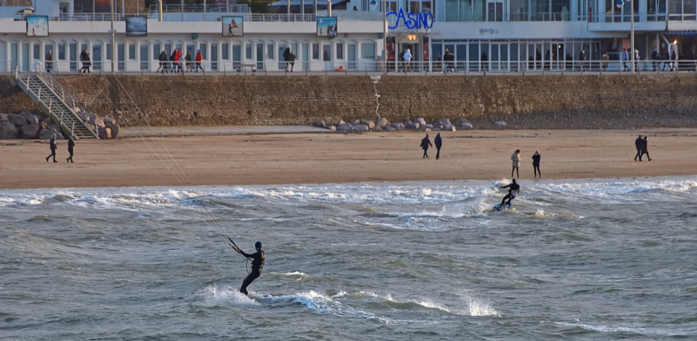 a group of people riding kiteboards on top of a body of water
