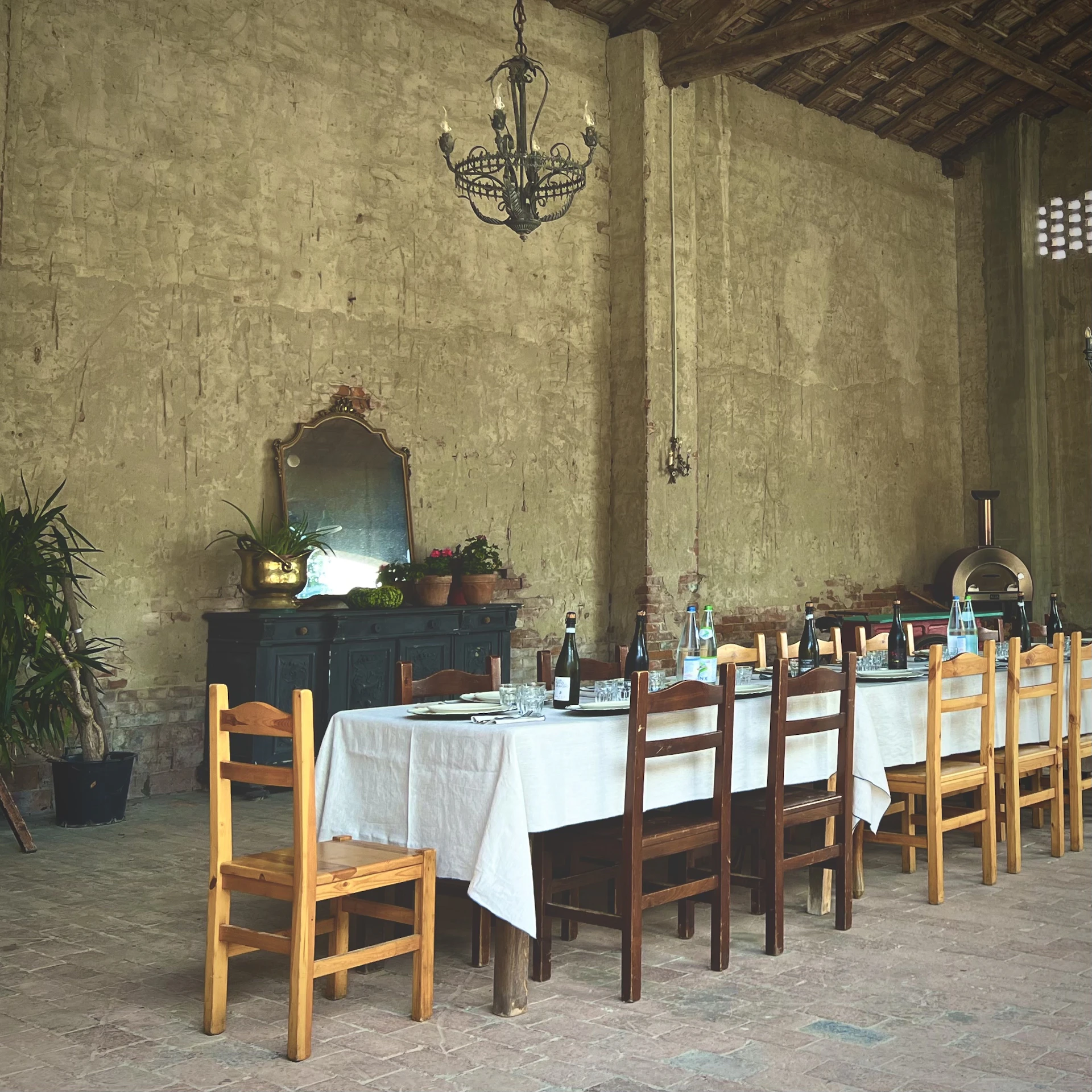 An inviting dining scene featuring a mix of vintage mid-century chairs around a butcher block table, with plates of traditional Acadian fare ready to be served.