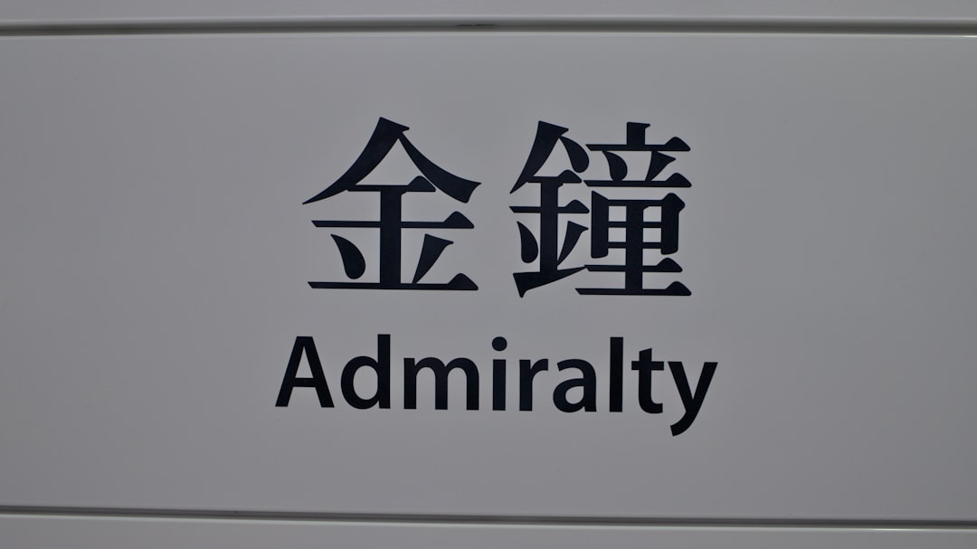 a close up of a sign with asian writing, Station name sign in Hong Kong MTR